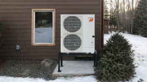 Mitsubishi Electric cold-climate heat pump elevated above the snow at an Île Perrot home.