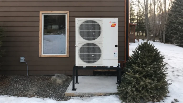Mitsubishi Electric cold-climate heat pump elevated above the snow at an Île Perrot home.