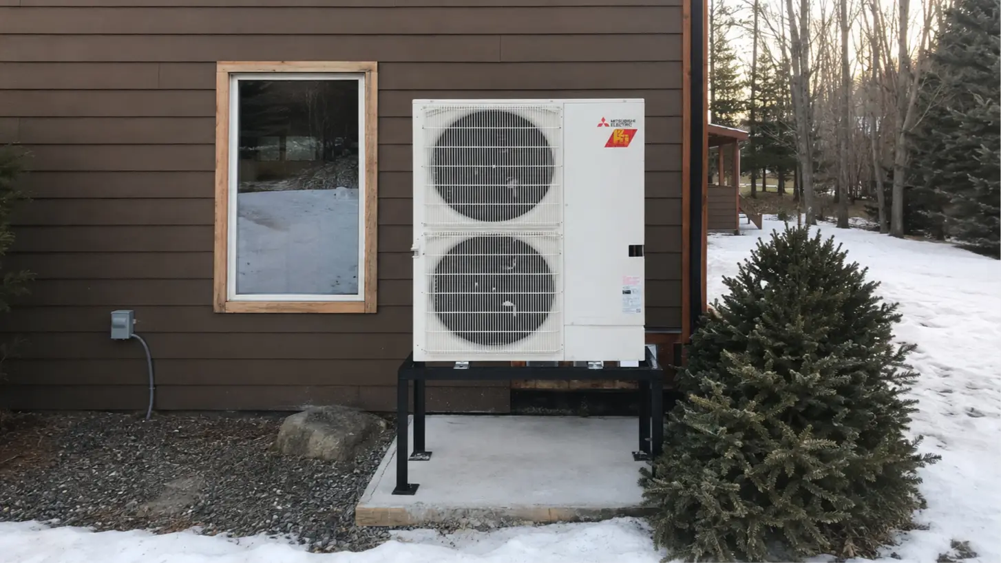 Mitsubishi Electric cold-climate heat pump elevated above the snow at an Île Perrot home.