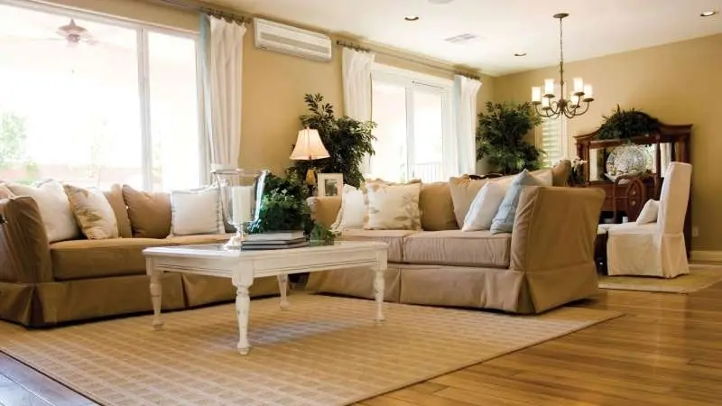 Wall-mounted heat pump heads serving separate home comfort zones