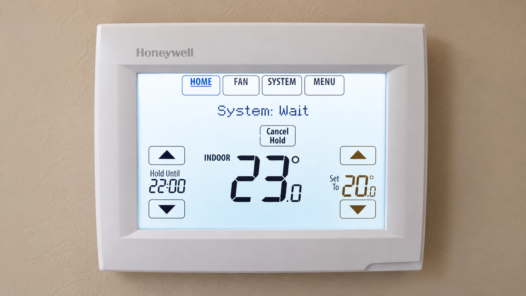 Honeywell wall thermostat displaying 23°C indoor temperature, 20°C set temperature, and System Wait status.