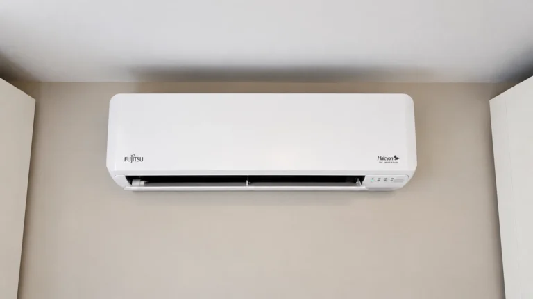 Fujitsu Halcyon wall-mounted mini-split air conditioner installed high on a beige interior wall.